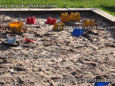 Stock image of raised sandpit in playground, bucket and spade, sandcastles