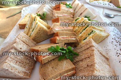 Stock image of triangular sandwiches, afternoon tea, egg / lettuce, smoked salmon, beef, ham, party food buffet