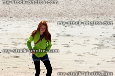 Stock image of girl on a scorching hot, sandy desert beach