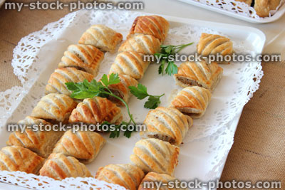 Stock image of freshly baked sausage rolls, party food, puff pastry, plate