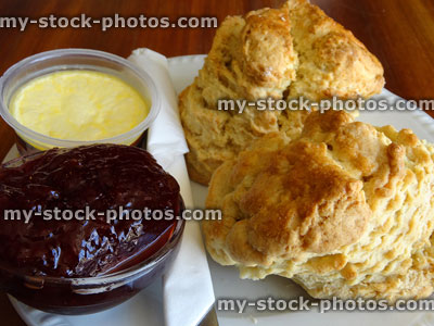 Stock image of traditional cream tea, homemade scones with jam, clotted cream