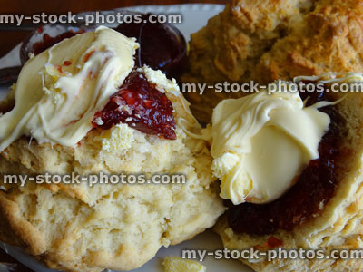 Stock image of close up of scones with clotted cream and strawberry jam