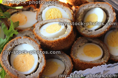Stock image of homemade Scotch eggs sliced in half, party food