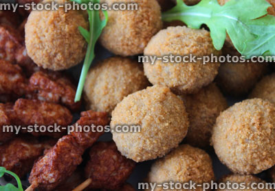 Stock image of mini Scotch eggs and chicken satay sticks, party food buffet