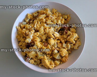 Stock image of bowl of scrambled eggs, ham and potato