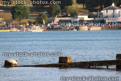 Stock image of wooden seaside groyne, sandy beach, sea defence, town, yachts