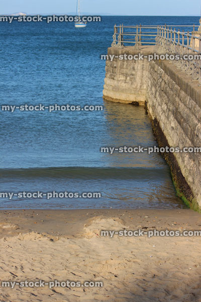 Stock image of English seaside, stone jetty / pier, Victorian railings, harbour