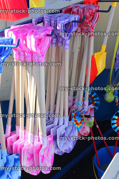 Stock image of wood / plastic seaside spades and buckets, beach gift shops