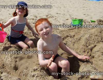 Stock image of children playing with sand on beach summer holiday