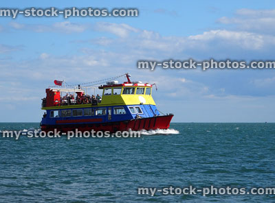 Stock image of distant passenger ferry cruising sea along Exmouth coastline
