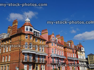 Stock image of brick and painted Edwardian townhouses with bay windows, chimneys