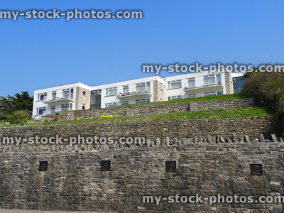 Stock image of dated flats built on steep hill slope, brick wall tiers
