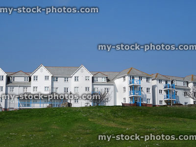 Stock image of white seaside terraced houses with balconies, hilltop views