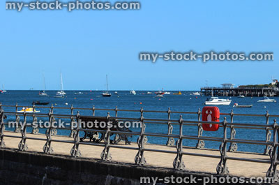 Stock image of English seaside, stone jetty / pier, Victorian railings, bench