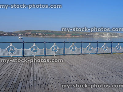 Stock image of ornate painted wrought iron railings overlooking Swanage beach / seaside