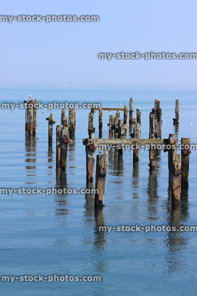 Stock image of old pier in Swanage, wooden stacks / posts / posts