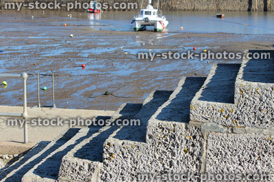 Stock image of concrete steps / stairs leading to seaside harbour, yachts