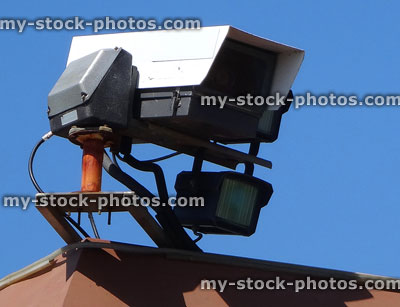 Stock image of CCTV security camera on town centre rooftop