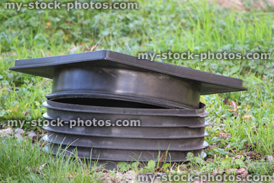 Stock image of black plastic septic tank cover, round / square manhole frame