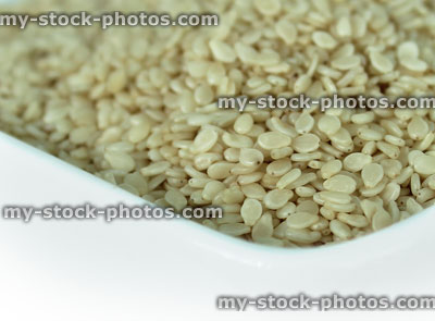 Stock image of sesame seeds in dish, health benefits, healthy food