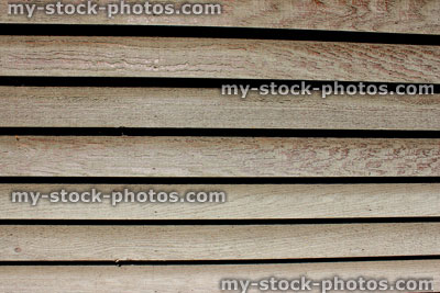 Stock image of weathered wooden slats on side of shed