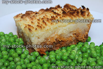 Stock image of cottage / shepherd's pie slice on plate with garden-peas