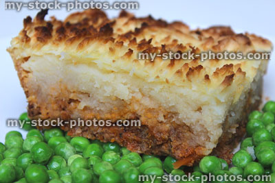 Stock image of shepherd's-pie / cottage-pie portion with boiled garden peas