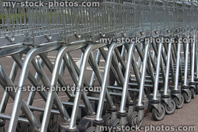 Stock image of shopping trolleys lined up outside in supermarket car park