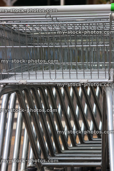 Stock image of shopping trolleys lined up outside in supermarket car park