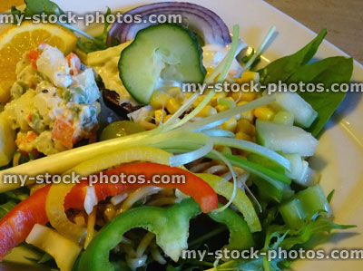 Stock image of mixed side salad, lettuce, rocket leaves, peppers, cucumber, coleslaw, red onion, sweetcorn, spring onion