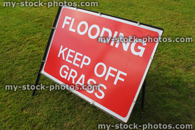Stock image of sign saying 'Flooding, Keep Off Grass' in park