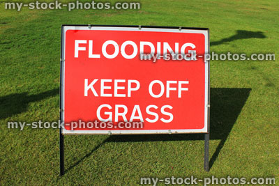 Stock image of sign saying 'Flooding, Keep Off Grass' in park