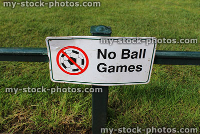 Stock image of sign saying 'No Ball Games' in park, signpost