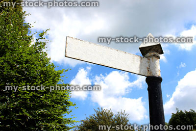 Stock image of blanked out, old fashioned white sign / signpost pointing