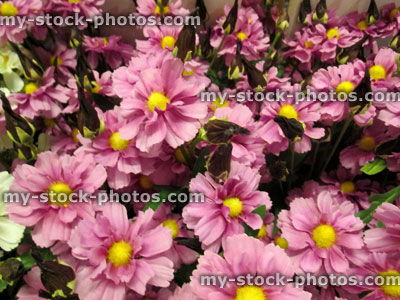 Stock image of plastic and silk pink daisies / artificial daisy flowers