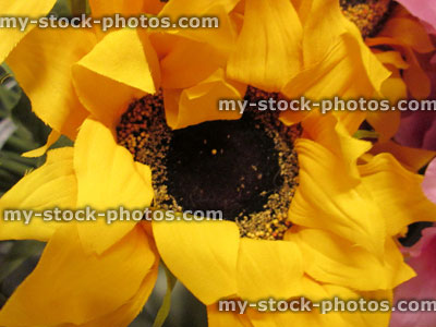 Stock image of plastic / silk sunflower (Helianthus annuus) / artificial yellow flower