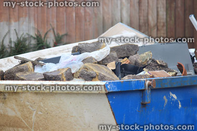 Stock image of blue skip filled with rubbish / refuse, dumpster recycling