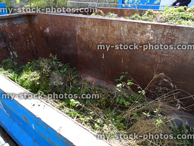 Stock image of green garden waste skips at rubbish dump / refuse recycling centre