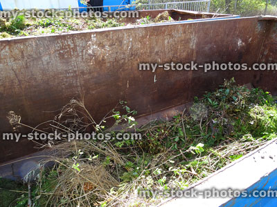 Stock image of green garden waste skip at rubbish dump / recycling