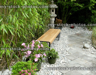 Stock image of slate tiles path, Japanese garden, bench, granite lantern, azaleas