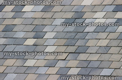 Stock image of natural, grey slate tiles on a house roof (close up)