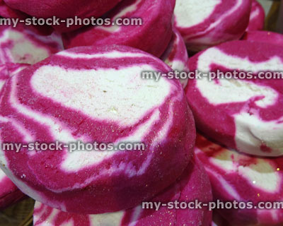 Stock image of pile of pink and white bath soap cakes with swirls