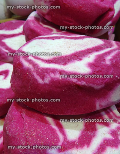 Stock image of pile of pink and white bath soap cakes with swirls