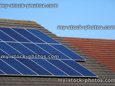 Stock image of solar panels on roof tiles, green power / energy