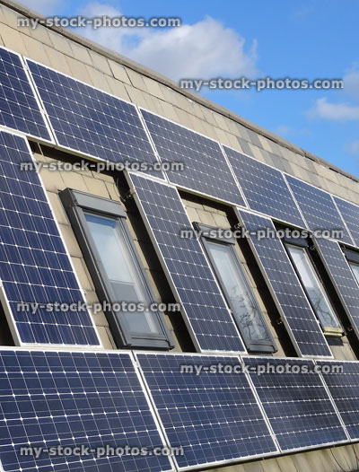 Stock image of solar panels around windows, renewable environmentally friendly energy