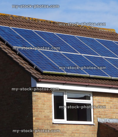 Stock image of modern house with solar panel cells on roof