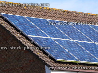 Stock image of solar panels on clay roof tiles, renewable energy source