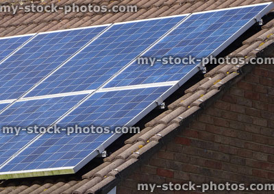 Stock image of solar energy panels on sunny south facing house roof
