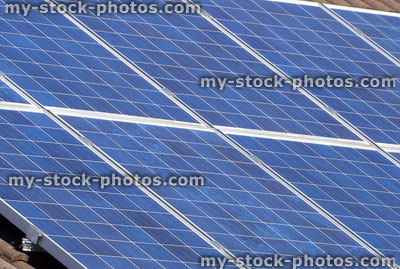 Stock image of solar panel cells on house roof, renewable energy