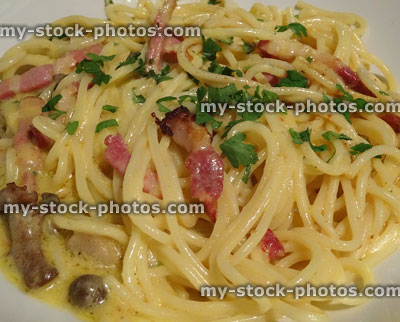Stock image of spaghetti carbonara in white dish with bacon, cheese